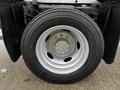 Close-up of a 2012 Ford F-550 wheel with a silver rim and a black tire featuring the size 225/70 R19.5