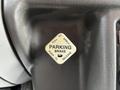 A parking brake lever labeled with instructions to pull to apply and push to release