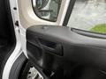 Interior view of the driver's side door panel of a 2018 RAM Promaster featuring a handle and controls