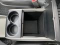 Interior console of a 2013 Toyota Sienna featuring two cup holders and a compartment below the lid