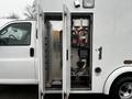 A 2016 Chevrolet Express with open side doors revealing mechanical and electronic components inside the vehicle