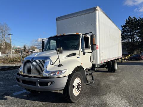 A 2013 International 4300 box truck with a white exterior featuring a distinctive grille and large cargo area on the back