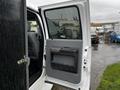 A 2014 Ford F-550 with an open driver's side door showcasing the interior and door panel details