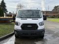 A 2023 Ford Transit van is shown from the front with a white exterior featuring a black grille and headlights