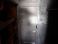 A silver metal door with a handle in a commercial vehicle interior