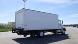 A 2009 Hino 268 medium-duty truck with a large white box cargo area and a flatbed rear end parked on an asphalt surface