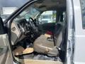 Interior view of a 2010 Ford F-550 showing worn driver's seat and dashboard area with visible wear and tear on the upholstery