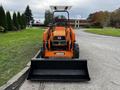 A 2001 Agco ST40 tractor with an attached front loader and a raised sunshade is parked on an asphalt surface facing forward