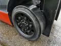 A close-up of a black wheel on a 2017 Toyota 8FCGCU25 forklift showing bolts and tire tread details