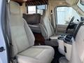 Interior view of a 2012 Ford Econoline with two front seats and a central console showing a spacious cab design