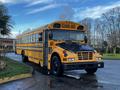 2005 Blue Bird 48 passenger school bus with yellow exterior and black features parked on a roadway