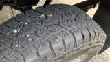 Close-up of a rugged tire tread on a 2013 RAM 2500 showcasing deep grooves and textures designed for off-road traction