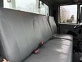 A gray bench seat in a 2007 International 4200 truck with seat belts and a minimalist design
