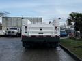 A 2017 Ford F-550 truck viewed from the rear with a white body and dual rear wheels featuring utility equipment mounted on the back