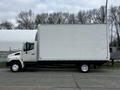A white 2006 Hino 268 box truck with a blank cargo area and six wheels parked on a street