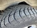 Close-up of a worn tire on a 2013 Ford Expedition showcasing its tread pattern and sidewall detail