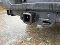 Close-up of the towing hitch receiver on a 2017 Ford F-350 SD with a rough texture and some water droplets visible