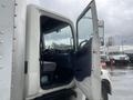 A 2008 Hino Conventional Cab with the driver's door open showing the interior features and seating area