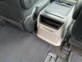 Interior view of a 2013 Toyota Sienna showing a center console between two seats with cup holders and an air vent