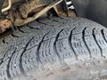 Close-up of a worn tire on a 2013 Ford Expedition showing detailed tread pattern and slight wear indicating usage
