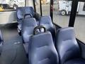 Interior view of a 2018 Chevrolet Express showing blue padded seats arranged in rows with armrests