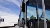 A 2011 Ford Econoline with a close-up view of its side mirrors and driver's window