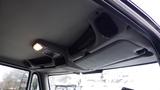 Interior view of a 2012 International TerraStar featuring the ceiling with speakers and storage compartments