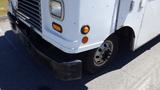 A white 2006 Ford Econoline van with a black front bumper and visible wear on the paint showcasing the vehicle's age and use