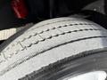 Close-up of a worn tire from a 1994 Freightliner FL80 showing tread patterns and a smooth surface