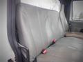 A gray leather bench seat from a 2006 International 4300 truck with two seatbelt latches visible in the front