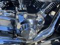 A close-up of a chrome engine component on a 2004 Harley-Davidson Flhtcui motorcycle showcasing intricate detailing and polished metal surfaces