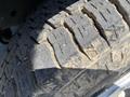 Close-up of a worn tire tread on a 2012 Ford Econoline showing significant wear and dirt embedded in the grooves