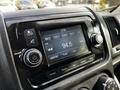 The dashboard of a 2019 RAM Promaster featuring a digital audio display with radio frequency options and control knobs for volume and tuning