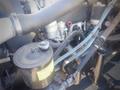 A close-up view of a 2006 Freightliner FS65 engine showing various components including hoses filters and pipes