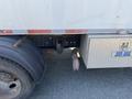 2010 Freightliner MT45 Garbage Truck featuring a large rear tire and a metallic storage box with a lock on the side