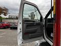 A 2008 Ford F-750 with an open driver's side door showcasing the interior door panel and handle