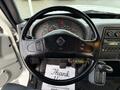 View of the steering wheel and dashboard of a 2007 International 4200 showing gauges controls and a message note on the floor