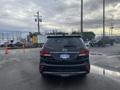 A black 2017 Hyundai Santa Fe seen from the rear with a visible license plate and rear tail lights