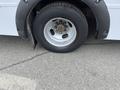 A 2017 Chevrolet Express with a close-up view of the front tire and wheel rim