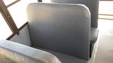 Interior view of a 2014 International 3000 school bus showing two gray vinyl seats with high backs