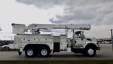 A 2008 International 7500 utility truck with a raised aerial lift and compartments for tools and equipment