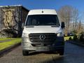 A 2021 Mercedes-Benz Sprinter van in white with a black front grille and emblem facing forward on a driveway