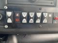 Control panel of a 2017 Chevrolet Express featuring various buttons for lights and functions including open and close switches and dome light controls