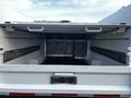 A 2017 Ford F-550 truck bed with a Knapheede utility body featuring open compartments and metal mesh dividers