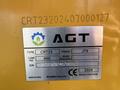 A metal identification plate featuring the logo and details for a 2024 AGT KTT23 Mini Skid Steer including type load width and serial number