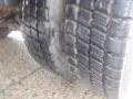 The image shows a close-up view of the tire tread of a 2009 Ford F-450 SD featuring deep grooves for traction and a rugged surface designed for heavy-duty use