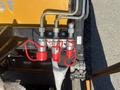 Close-up view of three hydraulic couplers with red protective caps on a 2024 AGT KTT23 Mini Skid Steer