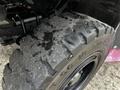 Close-up of a worn tire from a 2007 Tennant Sentinel showing significant tread wear and debris embedded in the rubber