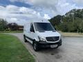 A white 2017 Mercedes-Benz Sprinter van parked on a road with a slight turn in the front view