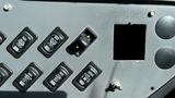 Control panel of a 2014 Freightliner Thomas Diesel bus featuring several black rocker switches and an empty rectangular slot